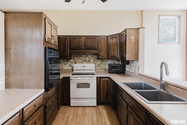 1437 Nassau Ln, Marion, IL 62959 - kitchen featuring black appliances, a sink, light wood-type flooring, backsplash, and light countertops