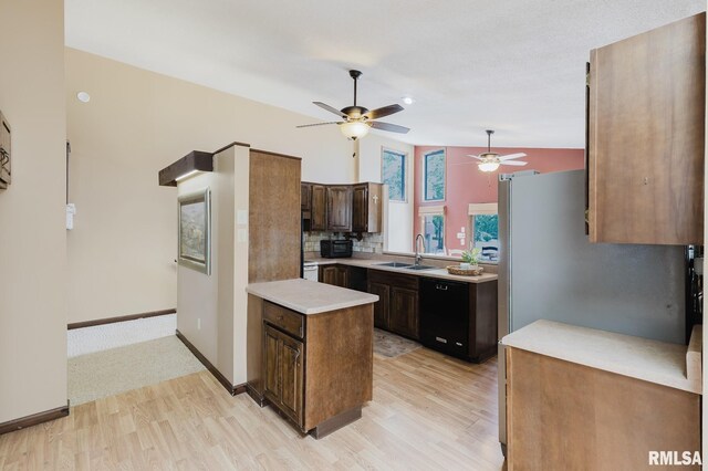 1437 Nassau Ln, Marion, IL 62959 - kitchen with a sink, black dishwasher, light wood finished floors, a ceiling fan, and vaulted ceiling