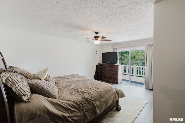 1437 Nassau Ln, Marion, IL 62959 - bedroom with access to exterior, a textured ceiling, wood finished floors, and a ceiling fan