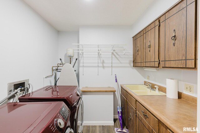 1437 Nassau Ln, Marion, IL 62959 - laundry area featuring independent washer and dryer, wood finished floors, and cabinet space