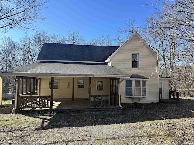 view of front of property with a porch and roof with shingles