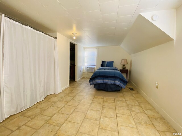 bedroom with lofted ceiling, visible vents, and baseboards