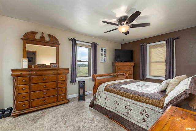 bedroom featuring light carpet, baseboards, and a ceiling fan