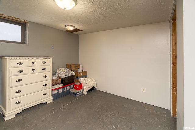 interior space featuring concrete floors and a textured ceiling