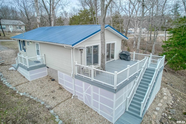 exterior space featuring metal roof and a deck