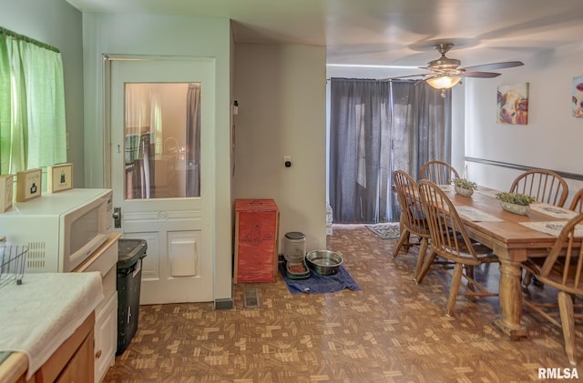 dining area featuring a ceiling fan and visible vents