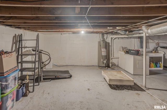 unfinished below grade area featuring gas water heater and washing machine and clothes dryer