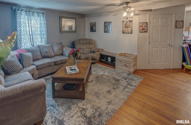 living area featuring ceiling fan and wood finished floors