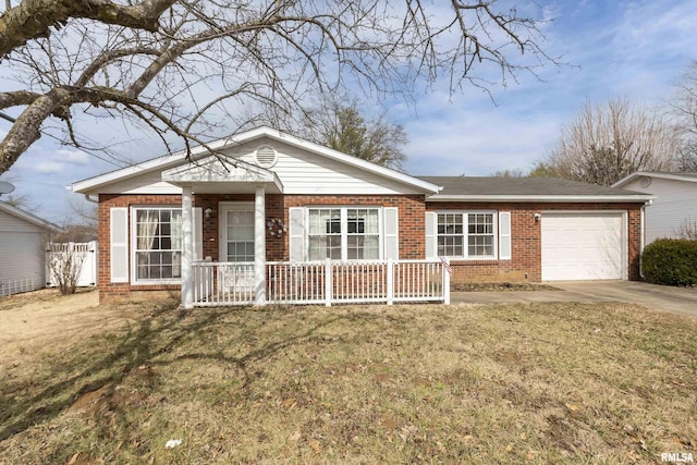 ranch-style home featuring brick siding, a porch, an attached garage, driveway, and a front lawn