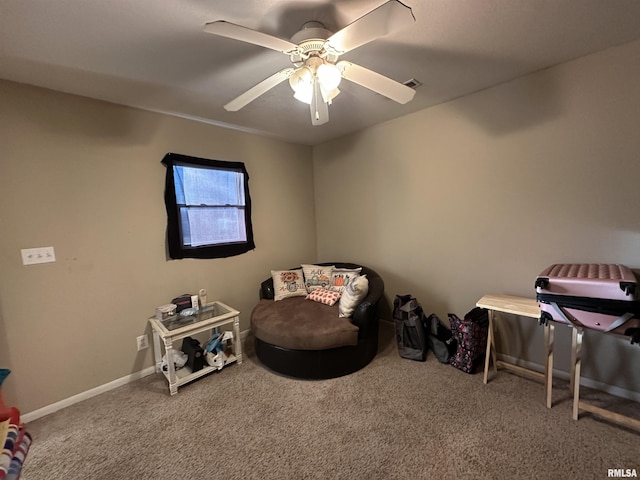 living area featuring carpet, visible vents, baseboards, and ceiling fan