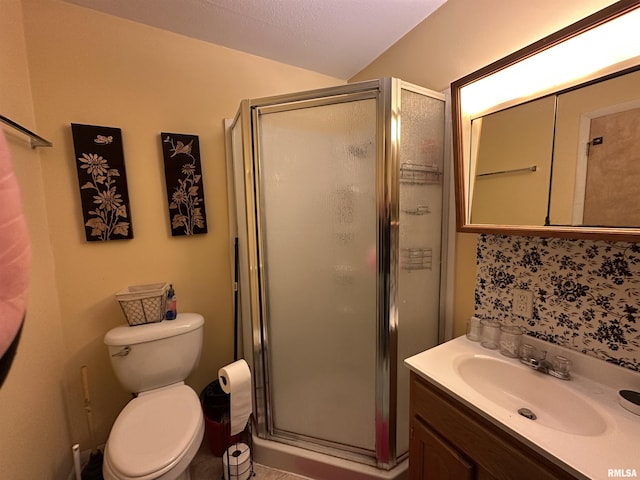 full bathroom with a stall shower, vanity, and toilet