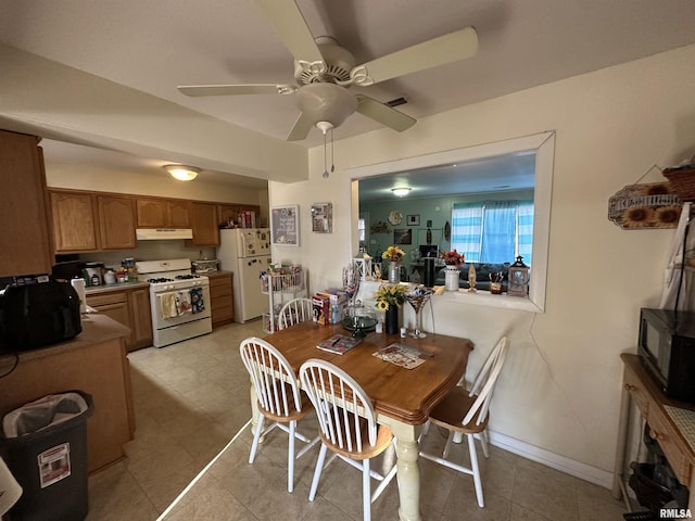 dining room with a ceiling fan, visible vents, and baseboards