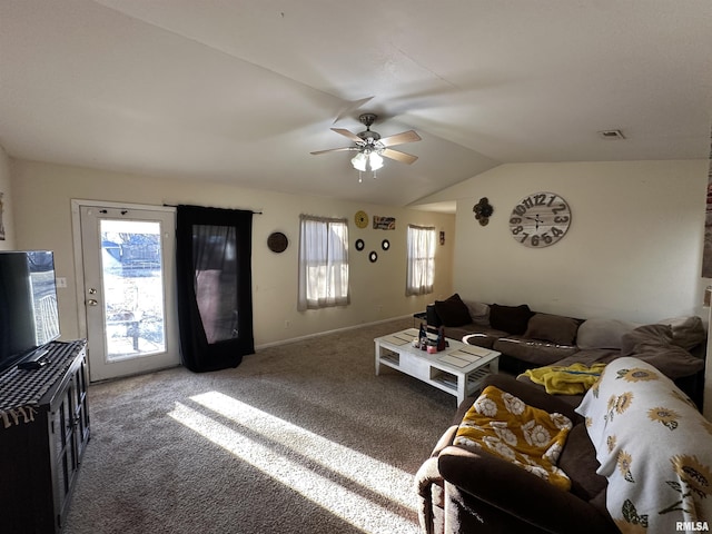 carpeted living room featuring a ceiling fan, visible vents, vaulted ceiling, and baseboards