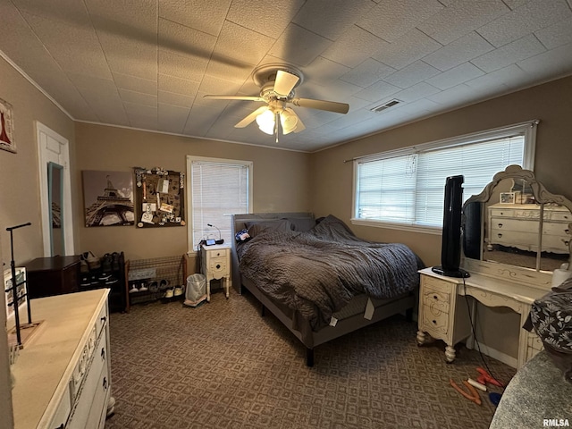 bedroom with visible vents and a ceiling fan