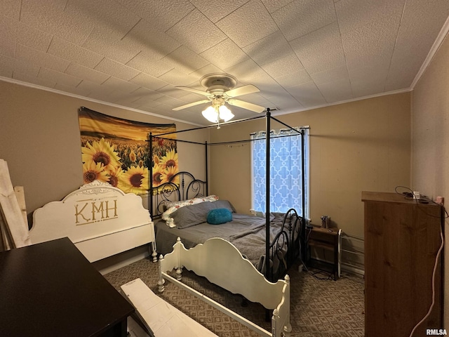 carpeted bedroom with ornamental molding and a ceiling fan