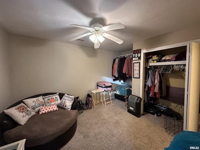 interior space featuring a closet, light colored carpet, ceiling fan, and visible vents