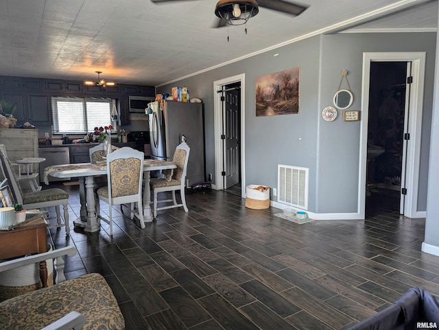 dining room featuring visible vents, baseboards, ornamental molding, wood tiled floor, and ceiling fan with notable chandelier