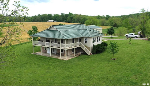 1548 Koehn Rd, Ava, IL 62907 - back of property featuring a standing seam roof, metal roof, a wooden deck, a patio area, and a yard
