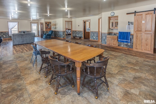1548 Koehn Rd, Ava, IL 62907 - dining space with a wainscoted wall, stone finish floor, and a barn door