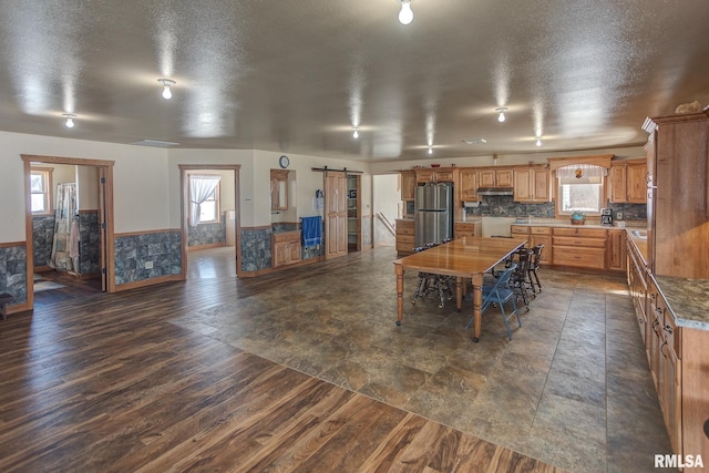 1548 Koehn Rd, Ava, IL 62907 - kitchen featuring freestanding refrigerator, plenty of natural light, a barn door, and a wainscoted wall