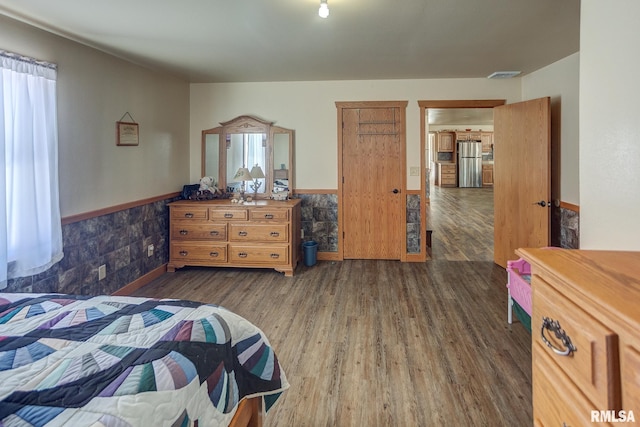 1548 Koehn Rd, Ava, IL 62907 - bedroom with freestanding refrigerator, dark wood-style flooring, and a wainscoted wall