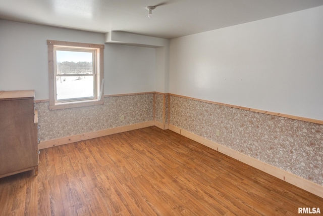 1548 Koehn Rd, Ava, IL 62907 - unfurnished room with baseboards, wallpapered walls, wainscoting, and wood finished floors