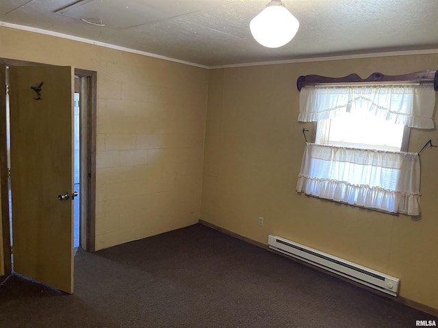 empty room featuring a baseboard heating unit, dark carpet, and concrete block wall