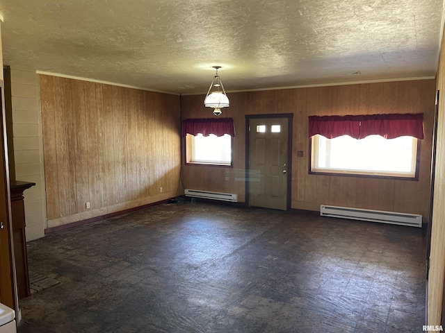 foyer entrance featuring wood walls, a baseboard heating unit, a textured ceiling, and tile patterned floors