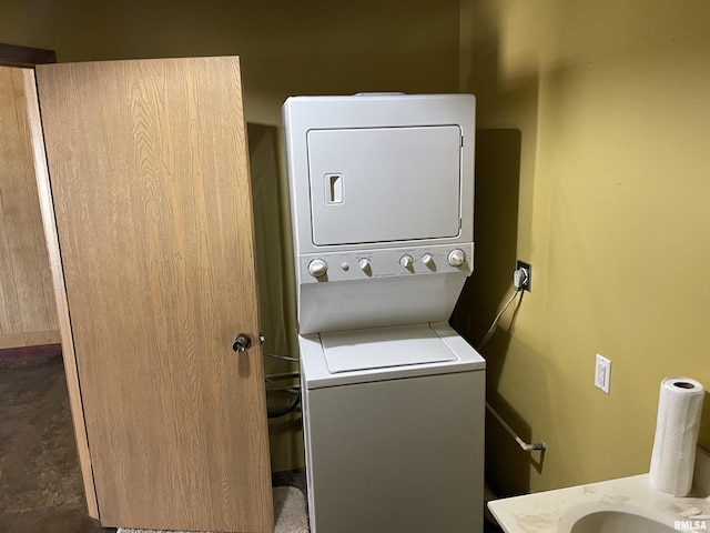 laundry room with stacked washer and clothes dryer and laundry area