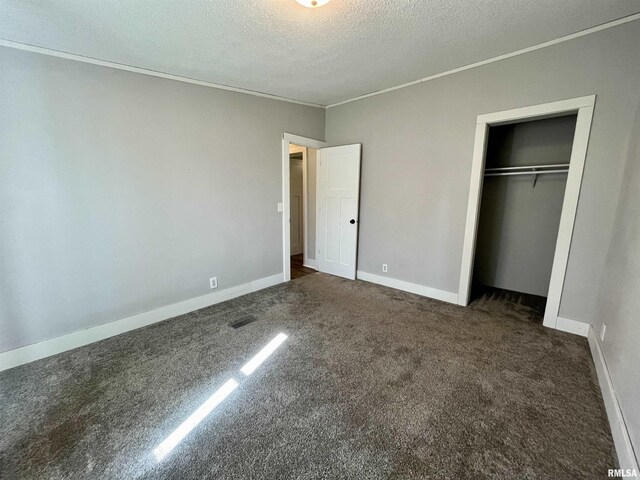 8065 E State Route 146th Hwy, Grantsburg, IL 62943 - unfurnished bedroom featuring carpet floors, a textured ceiling, ornamental molding, a closet, and baseboards