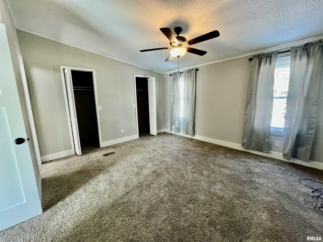 8065 E State Route 146th Hwy, Grantsburg, IL 62943 - unfurnished bedroom featuring a textured ceiling, two closets, carpet, ornamental molding, and baseboards