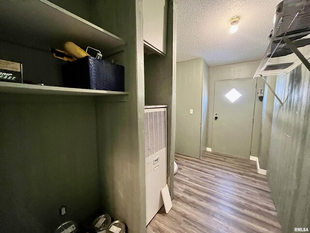 8065 E State Route 146th Hwy, Grantsburg, IL 62943 - interior space featuring a heating unit, wood finished floors, and a textured ceiling