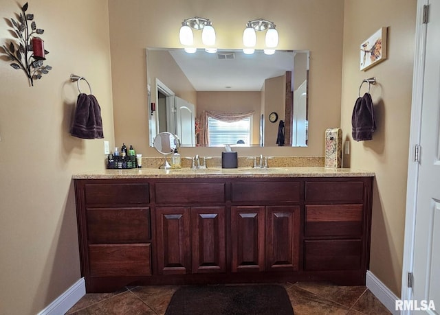 bathroom featuring tile patterned flooring, vanity, visible vents, and baseboards