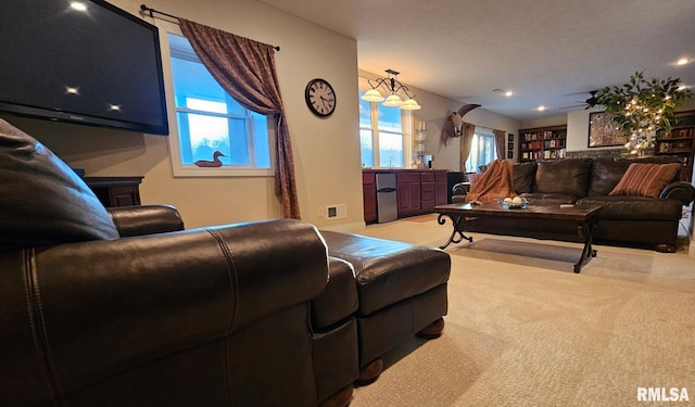 living area with carpet floors and visible vents