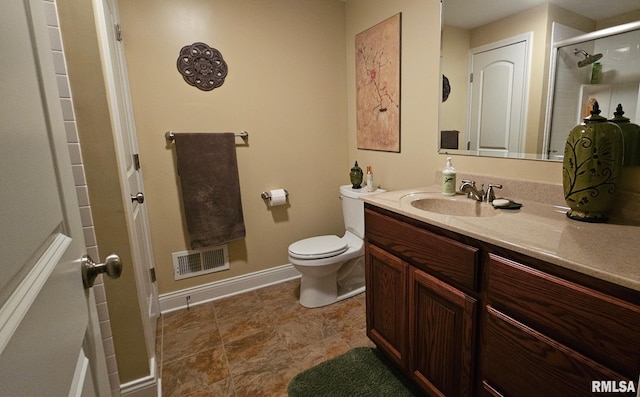 full bathroom with toilet, vanity, visible vents, baseboards, and a stall shower