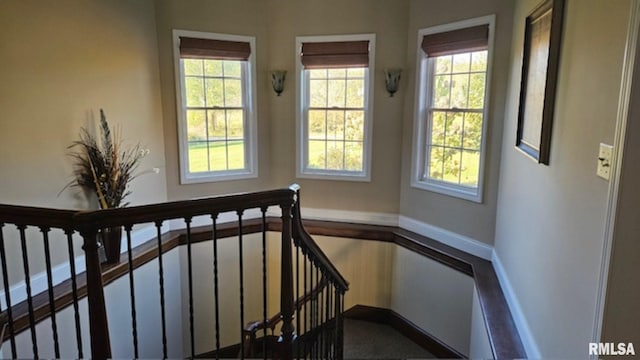 staircase with baseboards and a healthy amount of sunlight