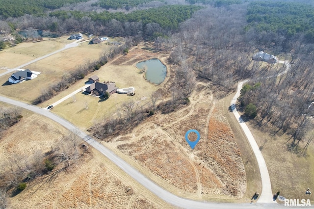 aerial view featuring a rural view and a wooded view