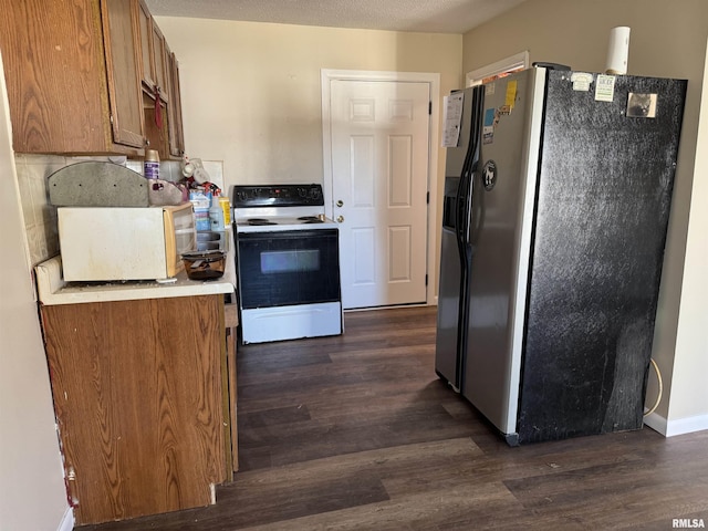 kitchen featuring electric range oven, dark wood-type flooring, fridge with ice dispenser, and brown cabinetry