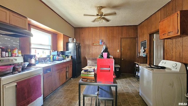 202 S Liberty St, Marion, IL 62959 - kitchen featuring stove, wooden walls, a ceiling fan, washer / clothes dryer, and freestanding refrigerator