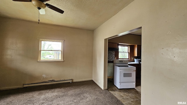 202 S Liberty St, Marion, IL 62959 - interior space featuring a baseboard heating unit, electric stove, ceiling fan, dark colored carpet, and a textured ceiling