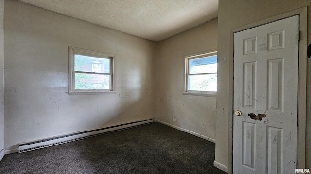 202 S Liberty St, Marion, IL 62959 - empty room featuring baseboards, dark colored carpet, and a baseboard radiator