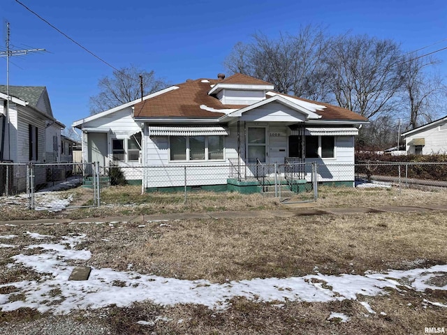 view of front of property with a fenced front yard and a gate