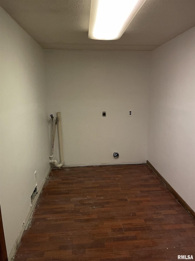 laundry room featuring laundry area, baseboards, and wood finished floors