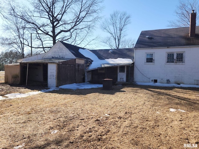 back of house featuring a chimney