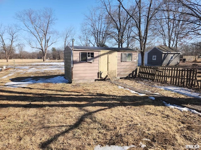 exterior space featuring an outbuilding and fence