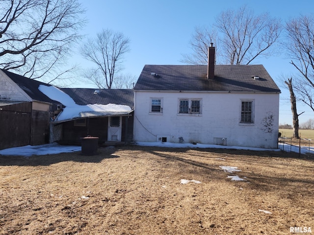 rear view of house with a chimney, a patio area, and fence