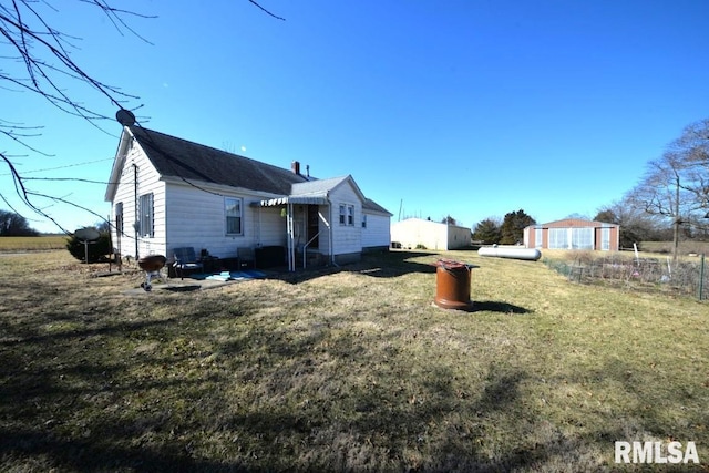 rear view of house with a lawn