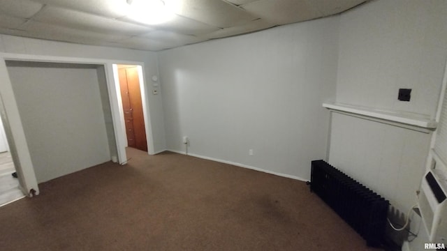 unfurnished bedroom with carpet floors and radiator