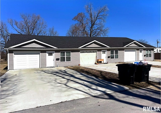 ranch-style home with a garage and concrete driveway