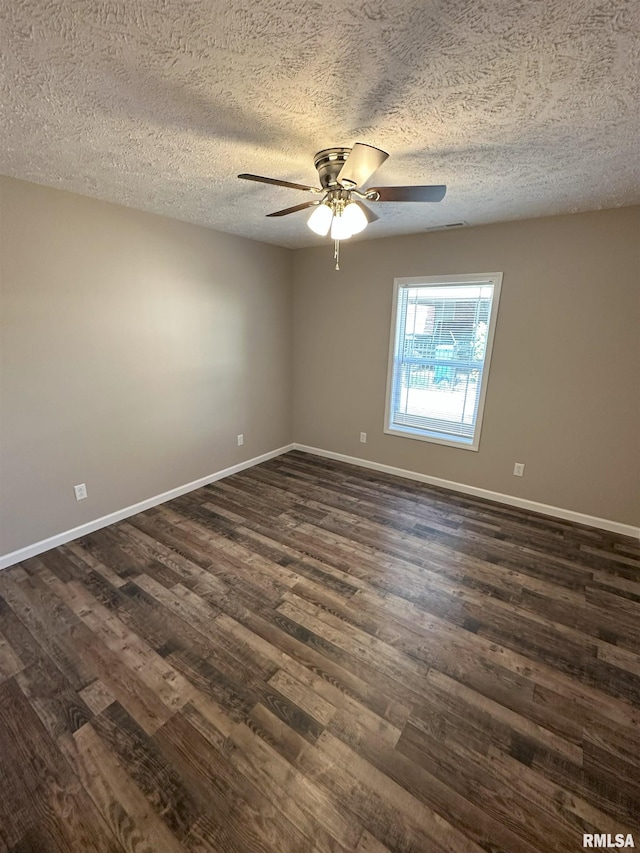 unfurnished room featuring dark wood-style floors, ceiling fan, a textured ceiling, and baseboards